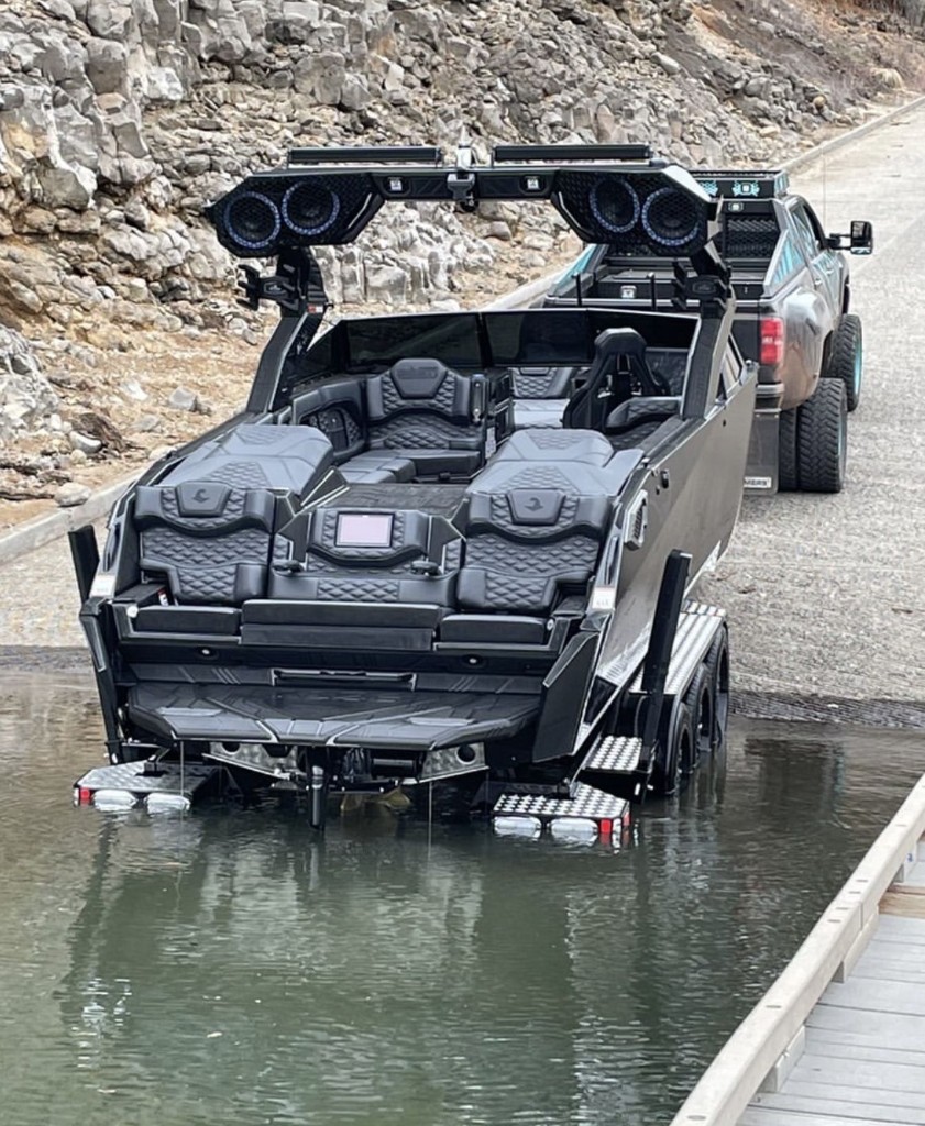 Wake boat on a ramp behind a dually pickup