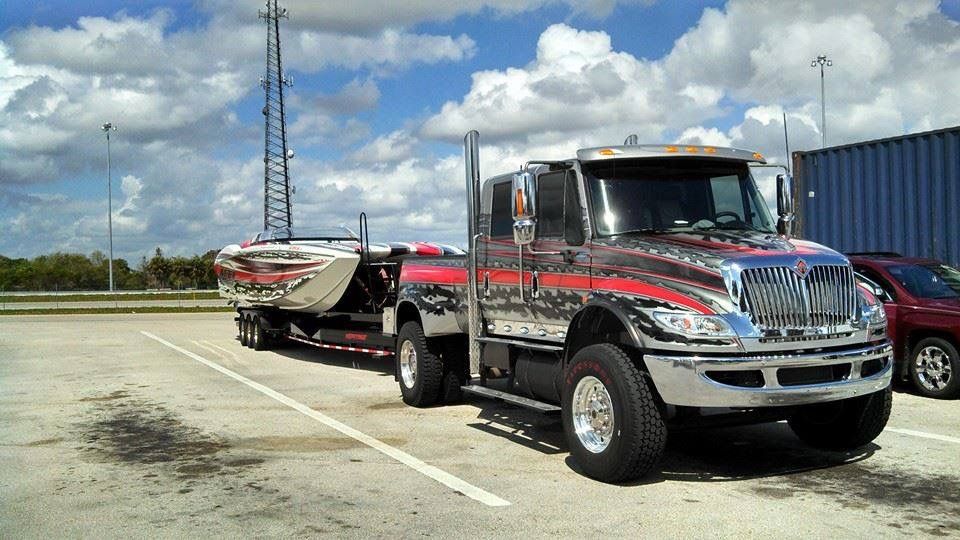 Semi truck towing a powerboat on a trailer