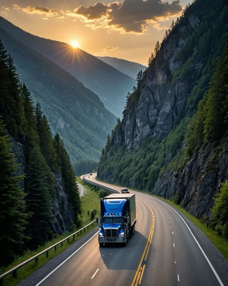 Blue semi truck with trailer on a winding mountain highway