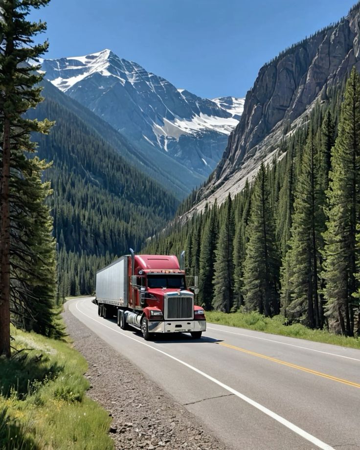 Red semi truck with white trailer on a mountain highway