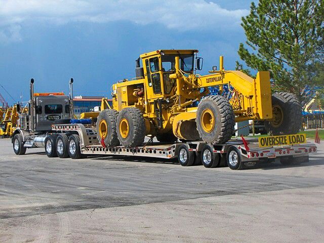 Motor grader on a lowboy trailer
