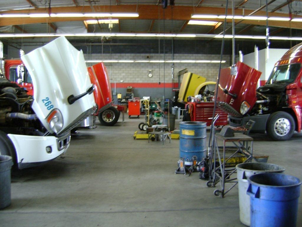 Truck service bay with multiple tractors under maintenance